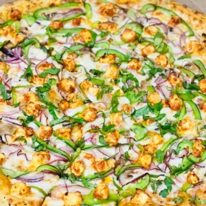 A closeup look at a pizza with some vegies on it.