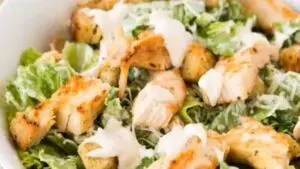 Chicken Caesar salad with croutons and dressing.