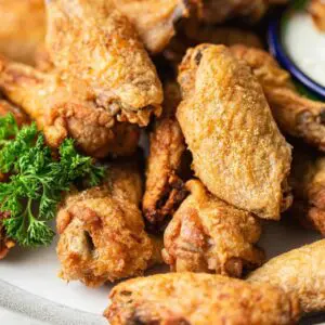 Crispy fried chicken wings on a plate.