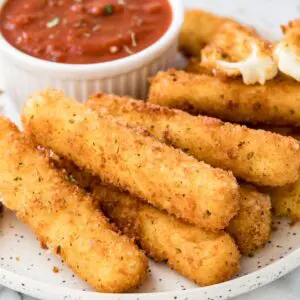 Crispy breaded mozzarella sticks with marinara sauce.