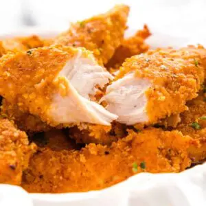 Crispy breaded chicken tenders in a bowl.