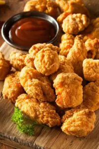 Crispy fried chicken nuggets with dipping sauce.