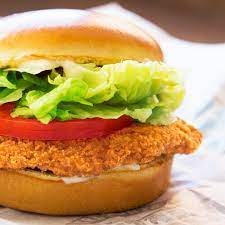 A crispy chicken sandwich with lettuce and tomato.