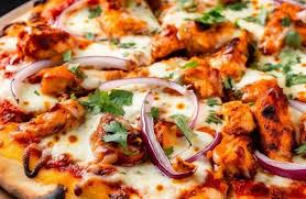 Close-up of chicken and red onion pizza.